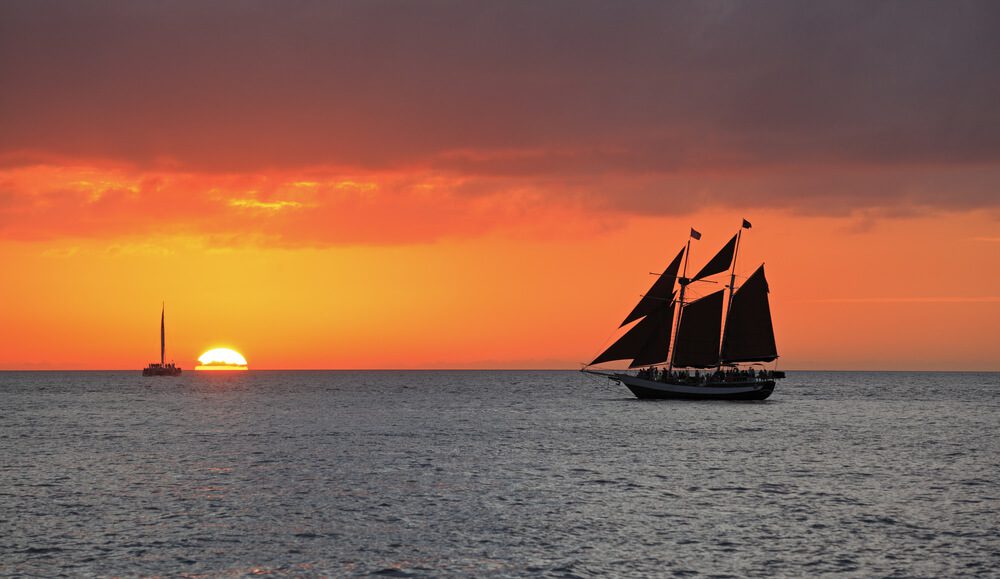 The view of ships sailing on the water during sunset in Key West.