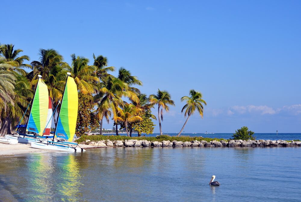 Two boats on the shore of one of the Key West beaches.